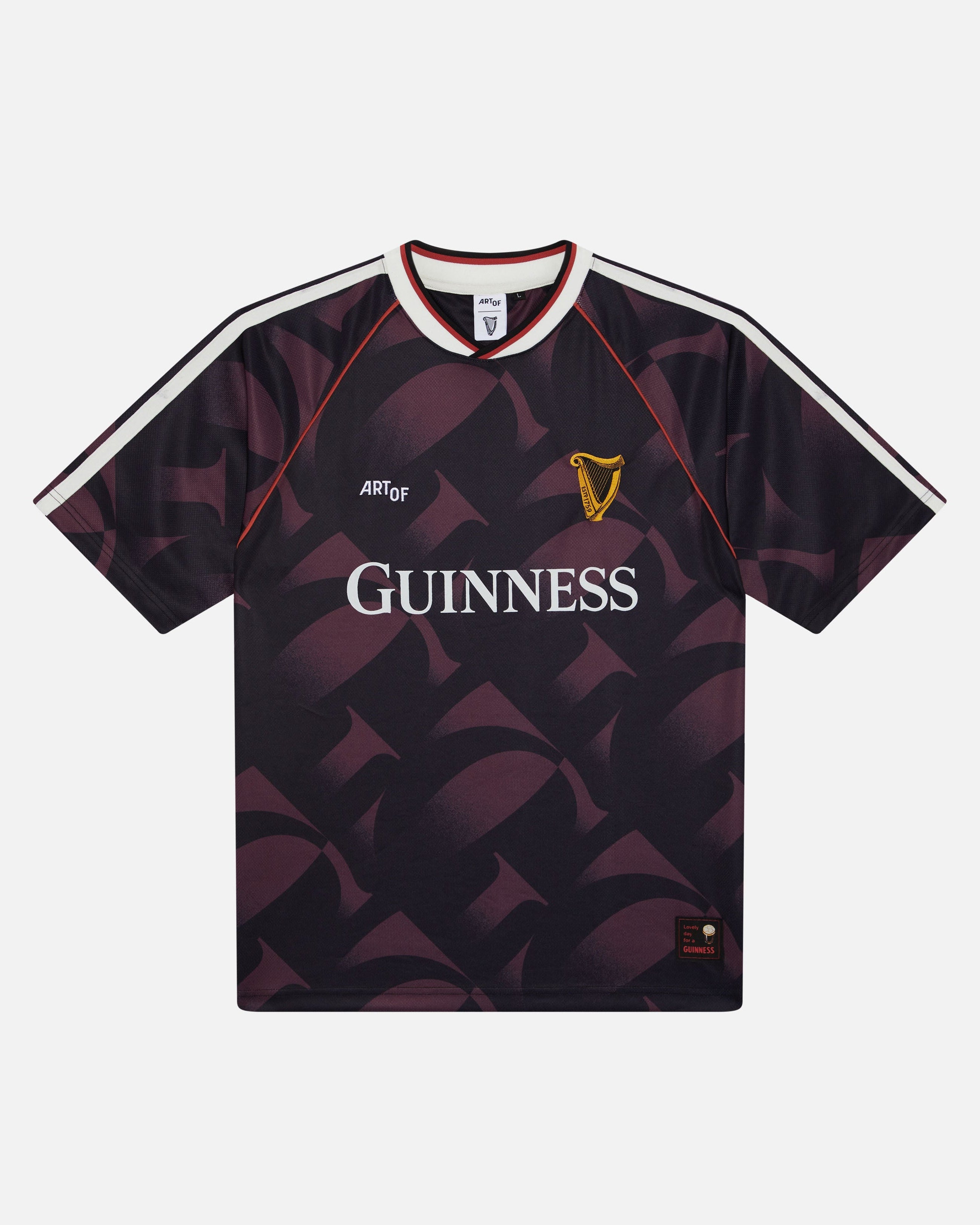 A short-sleeve Guinness football jersey with a dark purple and black geometric pattern, featuring the white 'GUINNESS' sponsor logo on the chest, a gold harp crest, and white shoulder stripes.